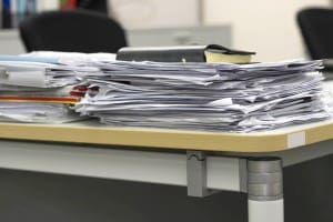 Paperwork on a cluttered desk